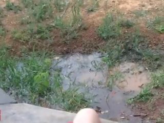 A little 18 years old damsel plays with a hose outdoors in jemagat öňünde